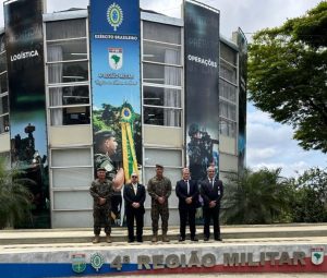 A imagem mostra cinco homens, entre civis e militares, na fachada da sede da 4ª Região Militar. O segundo da esquerda para a direita é o desembargador Jadir Silva
